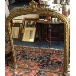 A tall gilt framed over mantle mirror. Est. £60 -