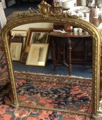 A tall gilt framed over mantle mirror. Est. £60 -