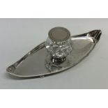 An Edwardian silver boat shaped inkwell with hinge