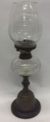 An etched glass oil lamp on brass circular base. E