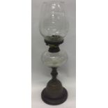 An etched glass oil lamp on brass circular base. E