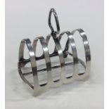 An Edwardian silver toast rack on bracket feet. Bi