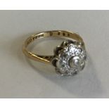 A small 18 carat gold diamond cluster ring. Approx