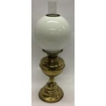 A brass mounted oil lamp. Est. £15 - £20.