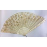 A carved ivory fan decorated with lacework. Est. £