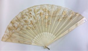 A carved ivory fan decorated with lacework. Est. £