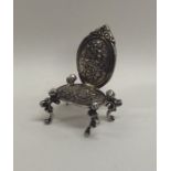 A silver doll's house carver chair with floral deco