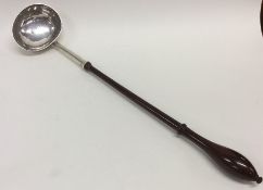 A Georgian silver toddy ladle on turned wooden han
