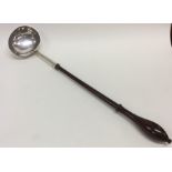 A Georgian silver toddy ladle on turned wooden han