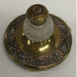 A copper and brass mounted circular inkwell with h