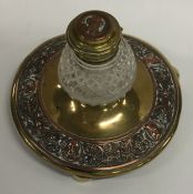 A copper and brass mounted circular inkwell with h