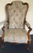 A walnut framed armchair decorated with flowers an