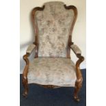 A walnut framed armchair decorated with flowers an