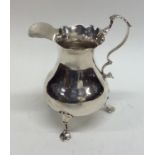 A Georgian silver helmet shaped cream jug with wav