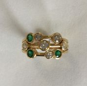 A modernistic 18 carat emerald and diamond ring in