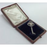 A cased silver presentation key. London. Approx. 8