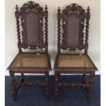 A pair of carved oak hall chairs. Est. £20 - £30.