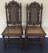 A pair of carved oak hall chairs. Est. £20 - £30.