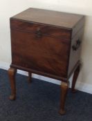 A mahogany cellerette with hinged top to fitted in