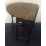 An Antique oak drop leaf table with plank top. Est