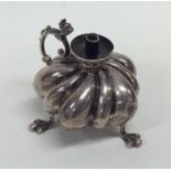 A novelty fluted silver burner with scroll decorat