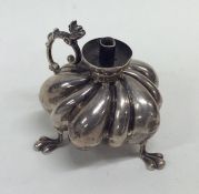 A novelty fluted silver burner with scroll decorat