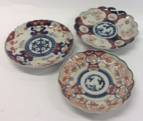 Three Imari plates of typical design. Est. £20 - £