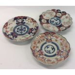 Three Imari plates of typical design. Est. £20 - £