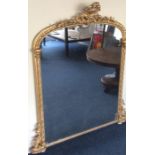 A massive gilt overmantle mirror decorated with sc