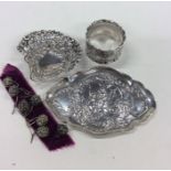 A small silver bonbon dish together with a napkin