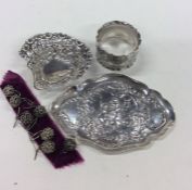 A small silver bonbon dish together with a napkin