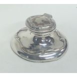 A small silver capstan shaped inkwell with hinged