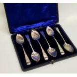 A boxed set of six bright cut Georgian silver teas