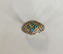 A turquoise four stone ring in gold. Approx. 3 gra