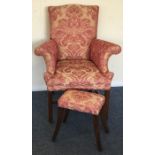 A pink upholstered armchair together with matching