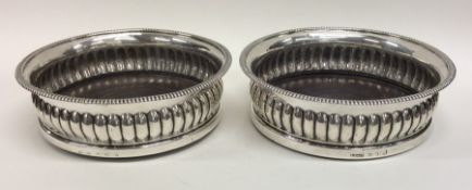 A good pair of Georgian silver half fluted wine co