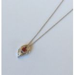 An attractive ruby and diamond pendant with loop t