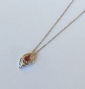 An attractive ruby and diamond pendant with loop t