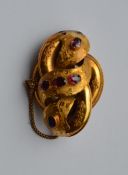 A Victorian gold brooch decorated with amethysts.