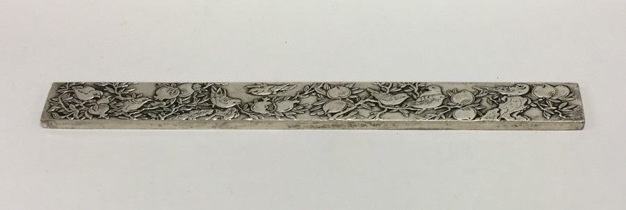 A heavy Chinese silver ingot decorated with birds.