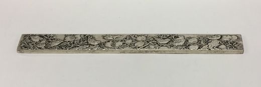 A heavy Chinese silver ingot decorated with birds.