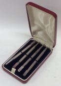 A cased set of four silver Bridge pencils with eng