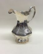 A large Victorian silver cream jug decorated with