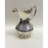 A large Victorian silver cream jug decorated with