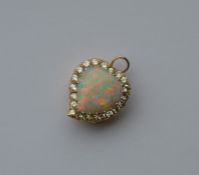 A large opal and diamond brooch in the form of a w