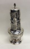 A heavy embossed baluster shaped silver caster dec
