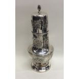 A heavy embossed baluster shaped silver caster dec