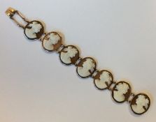 A 9 carat seven panel shell cameo bracelet in gold