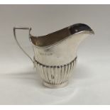A small silver bachelor's half fluted cream jug. B