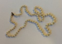 A graduated string of cultured pearls with ring cl